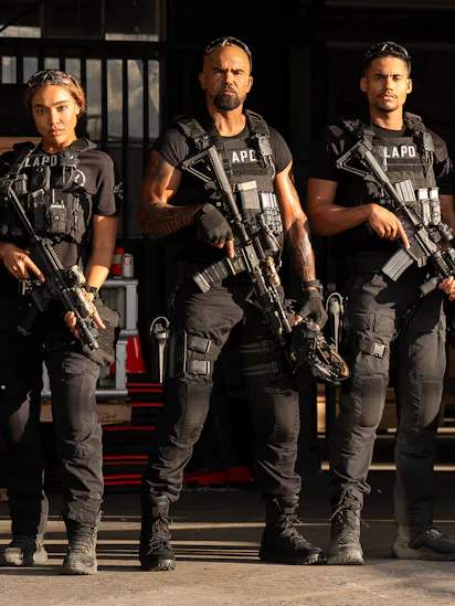 The cast of S.W.A.T. Exiles posing in tactical gear with guns